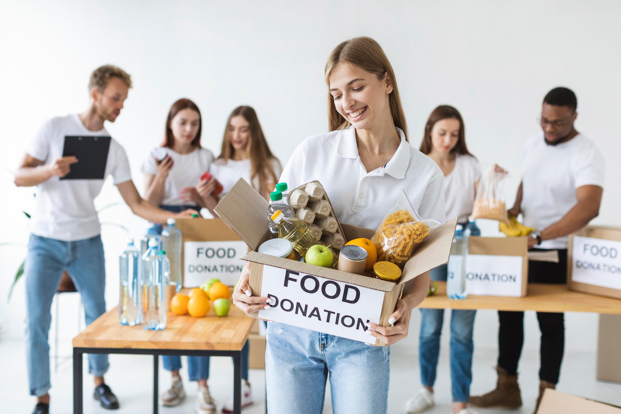 smiley-female-volunteer-holding-food-donations-box (1)